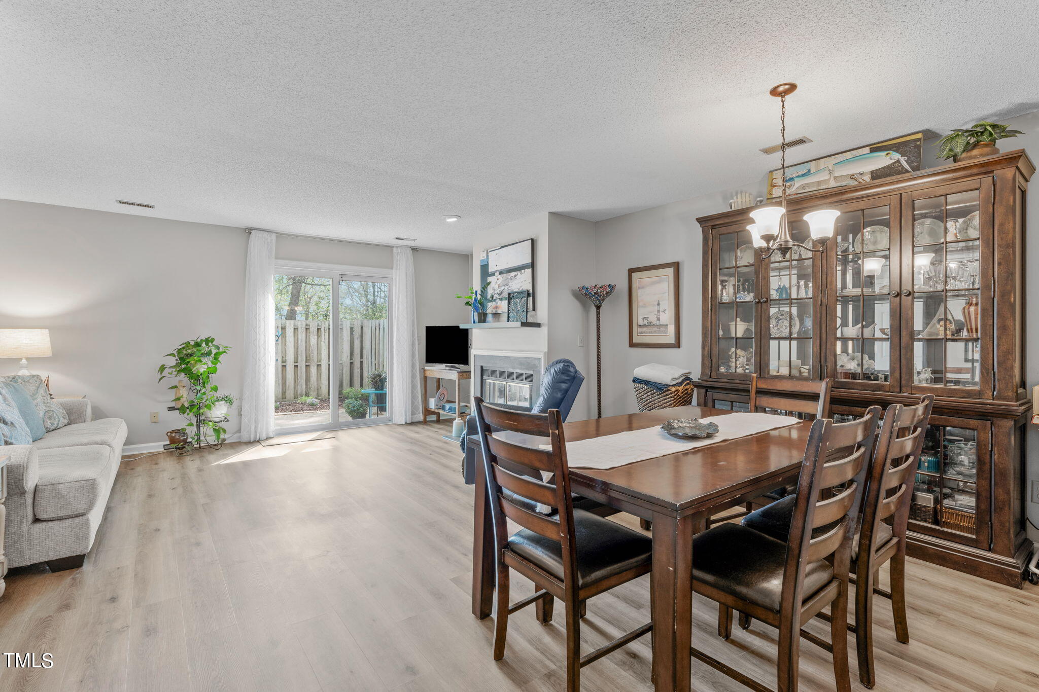 6908 Saxby Court Raleigh, NC 27613 - Photo 11 of 27 a view of a dining room with furniture window and wooden floor