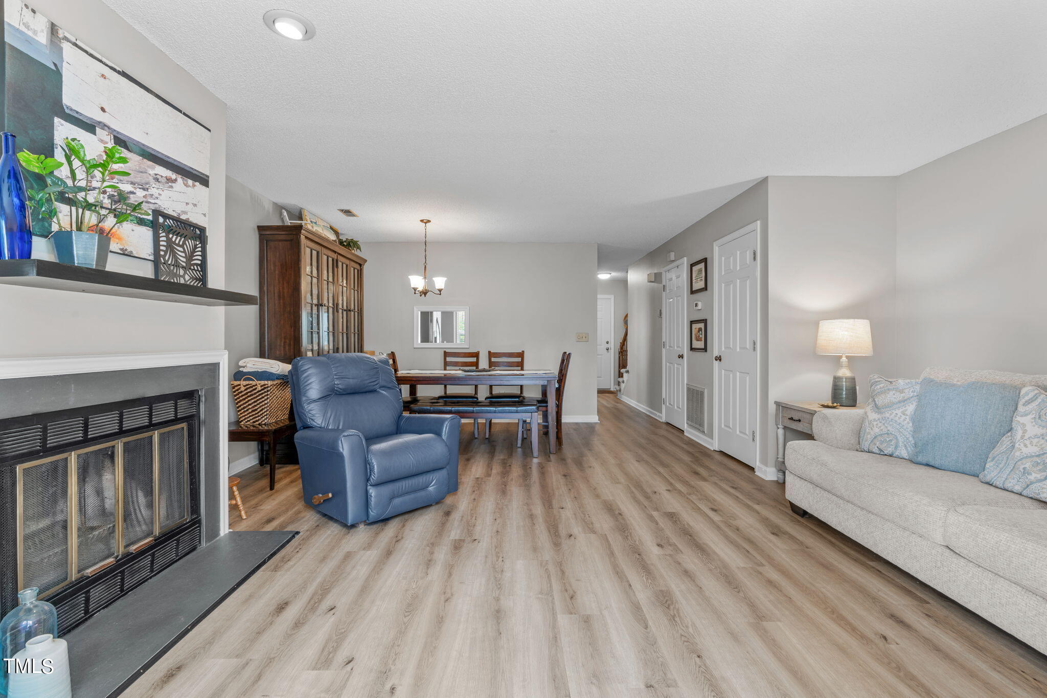 6908 Saxby Court Raleigh, NC 27613 - Photo 14 of 27 a living room with furniture and a fireplace