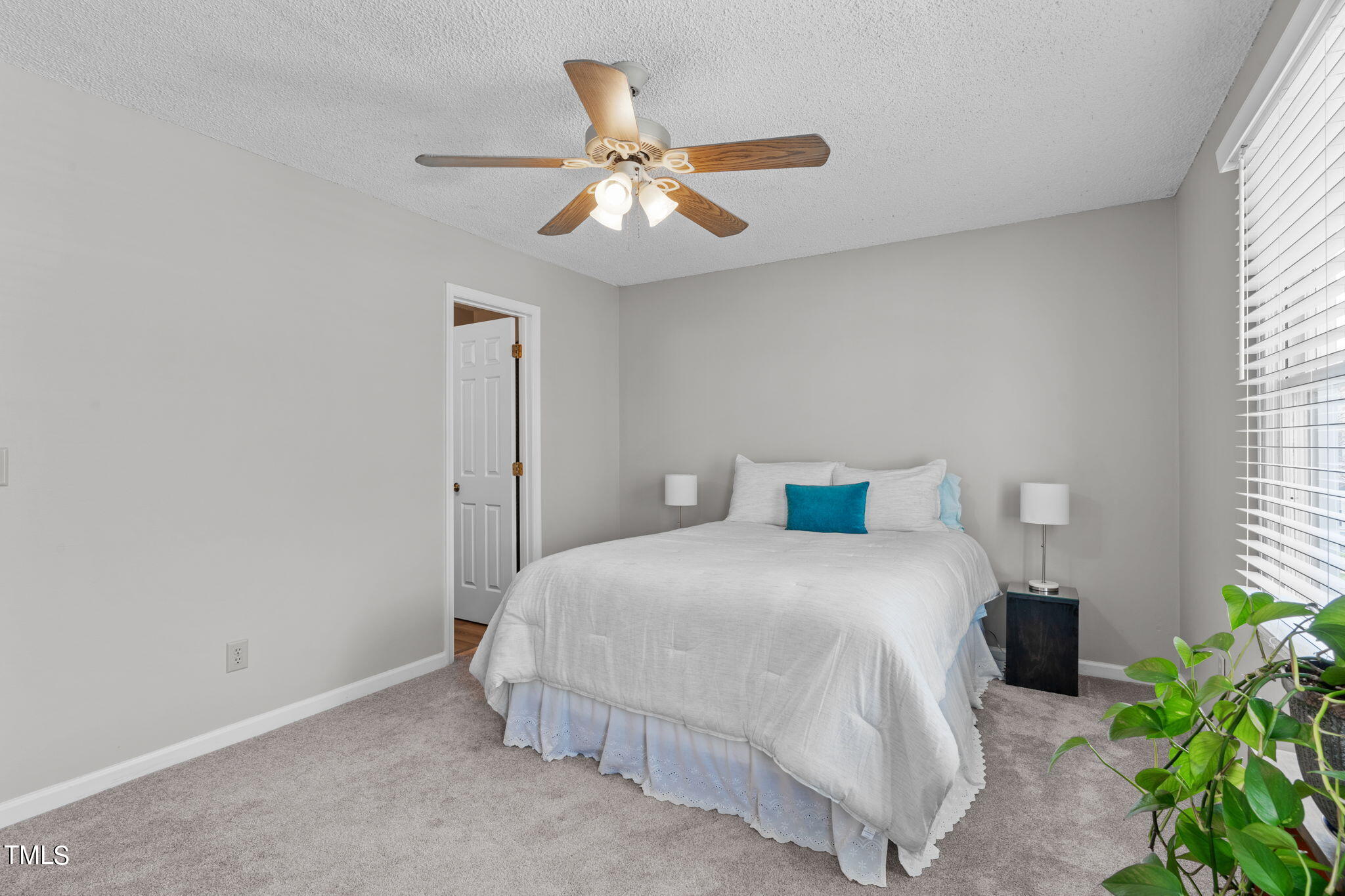 6908 Saxby Court Raleigh, NC 27613 - Photo 17 of 27 a bedroom with a bed and ceiling fan