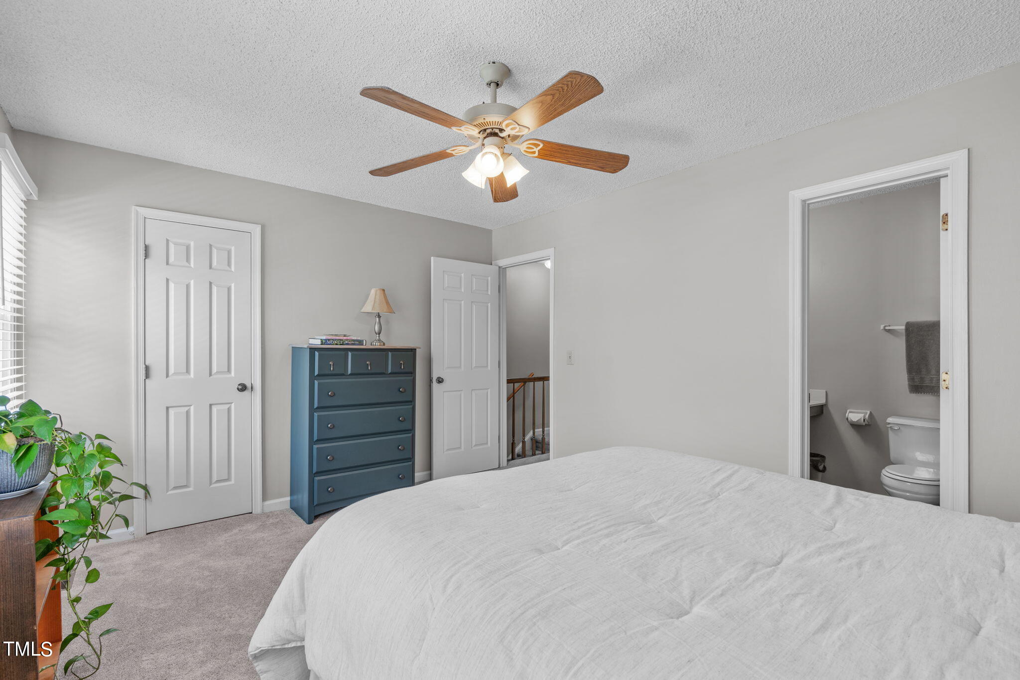 6908 Saxby Court Raleigh, NC 27613 - Photo 18 of 27 a bedroom with a bed and a chandelier