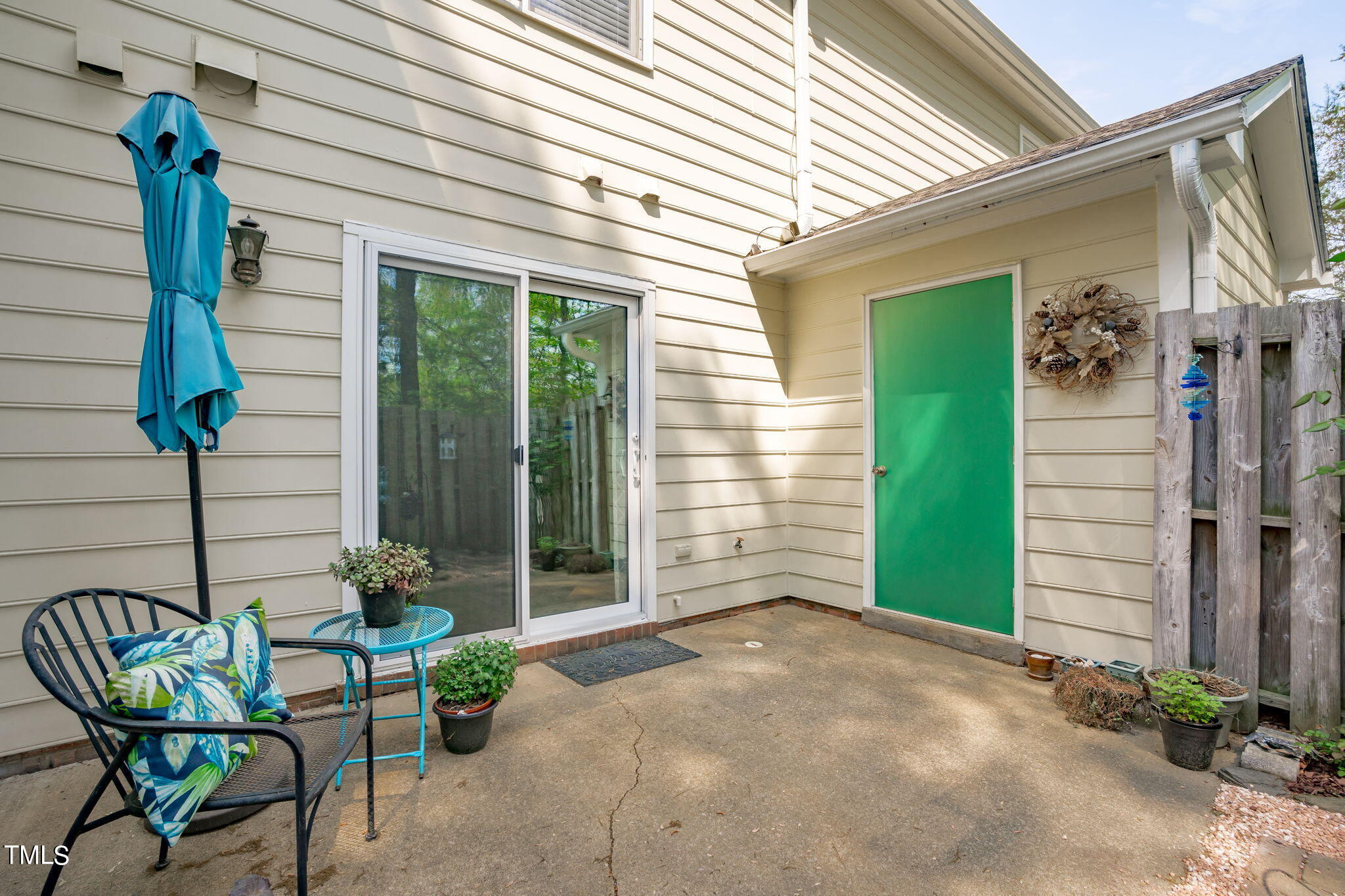 6908 Saxby Court Raleigh, NC 27613 - Photo 25 of 27 a view of backyard with outdoor seating and a potted plant