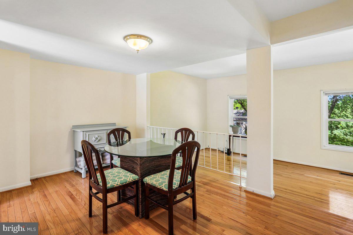 76 Timber Rock Road Gaithersburg, MD 20878 - Photo 16 of 51 a view of a dining room with furniture and wooden floor