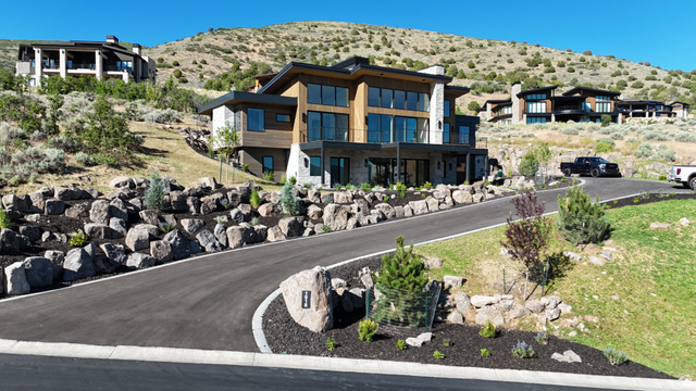 1918 Chimney Rock Road Heber City, UT 84032 - Photo 15 of 74 Contemporary hillside residence featuring extensive glass windows, a stone and wood facade, and multiple outdoor living spaces