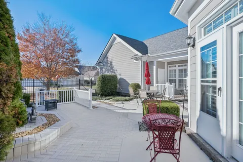 a patio with couches table and chairs and potted plants