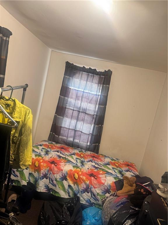 756 Linwood Street Brooklyn, NY 11208 - Photo 12 of 17 a bedroom with a bed and a window