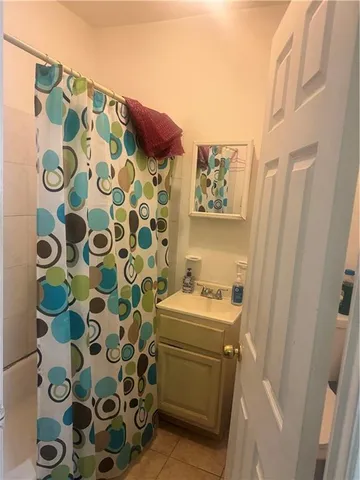 a bathroom with a sink and mirror with toilet