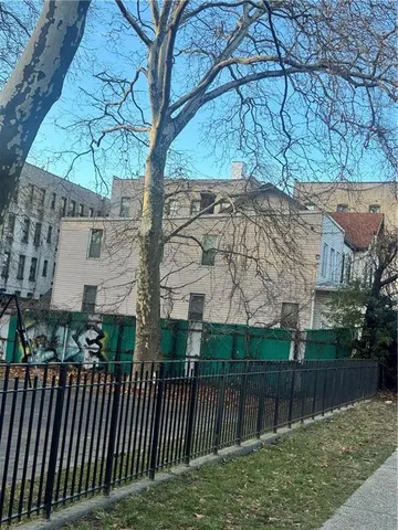 a view of house with a yard