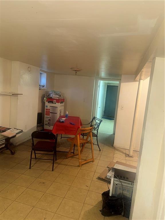 756 Linwood Street Brooklyn, NY 11208 - Photo 10 of 17 a living room with furniture and a mirror