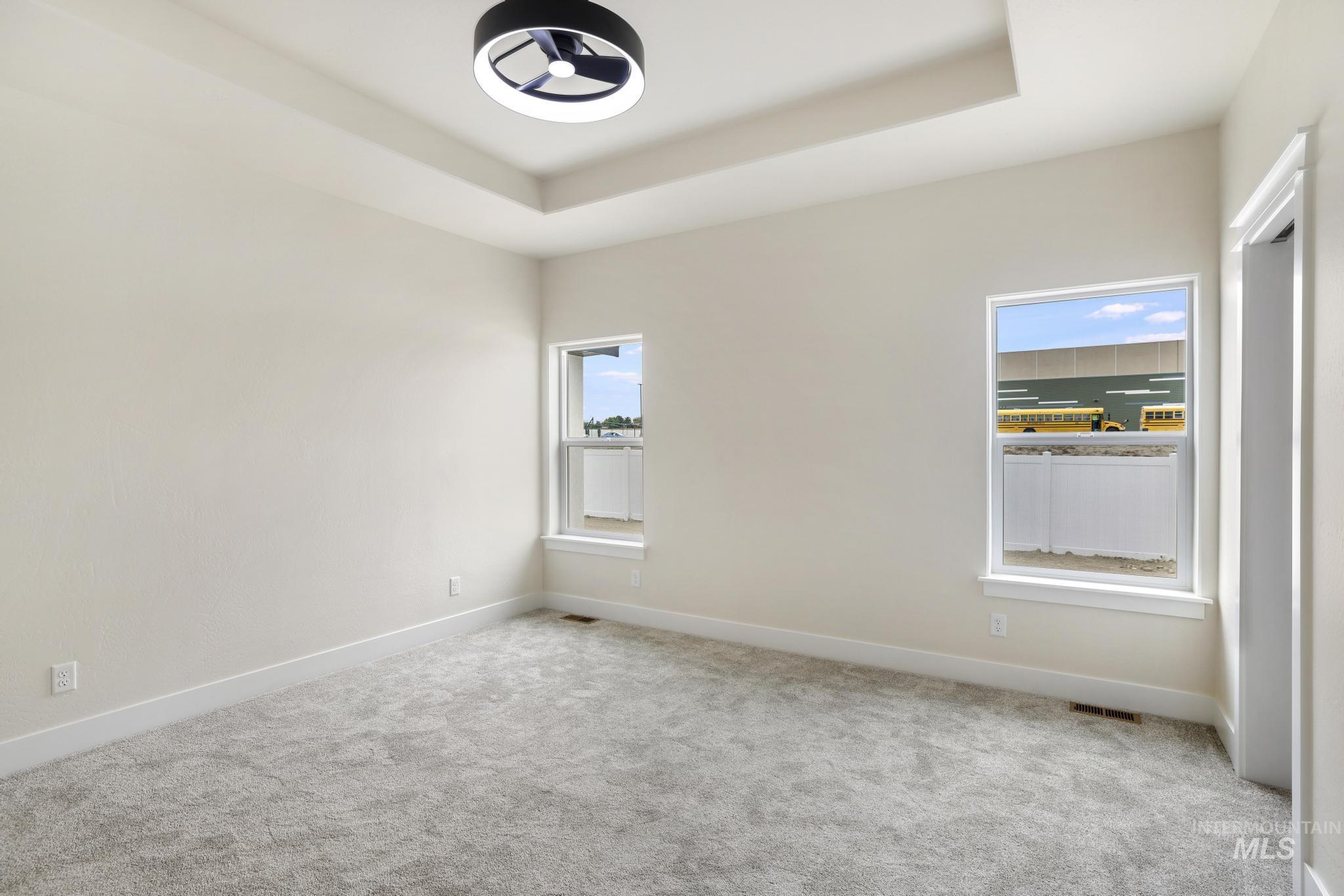 928 Gregory Way Twin Falls, ID 83301 - Photo 14 of 24 Carpeted empty room featuring a tray ceiling