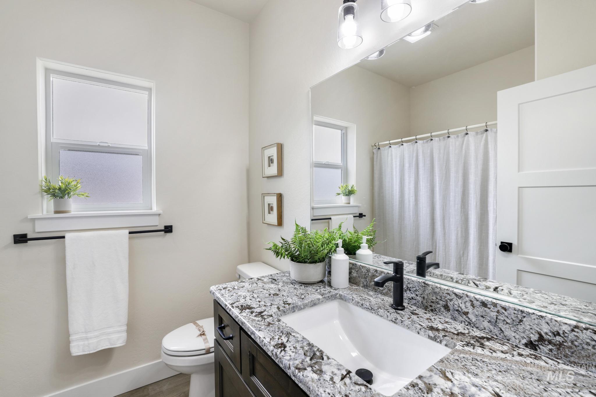 928 Gregory Way Twin Falls, ID 83301 - Photo 19 of 24 Bathroom featuring vanity and a shower with shower curtain