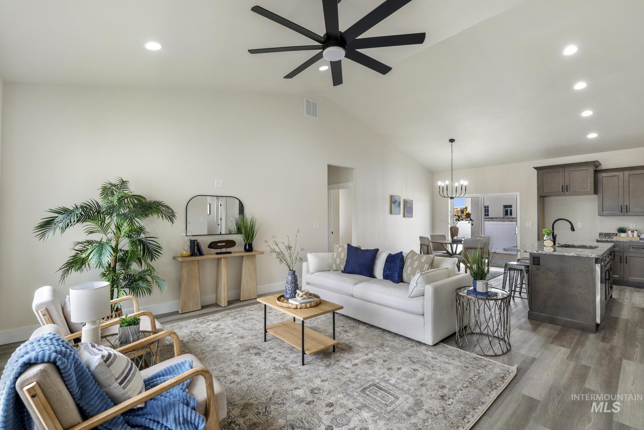 928 Gregory Way Twin Falls, ID 83301 - Photo 4 of 24 Living room featuring wood finished floors, recessed lighting, lofted ceiling, a chandelier, and ceiling fan