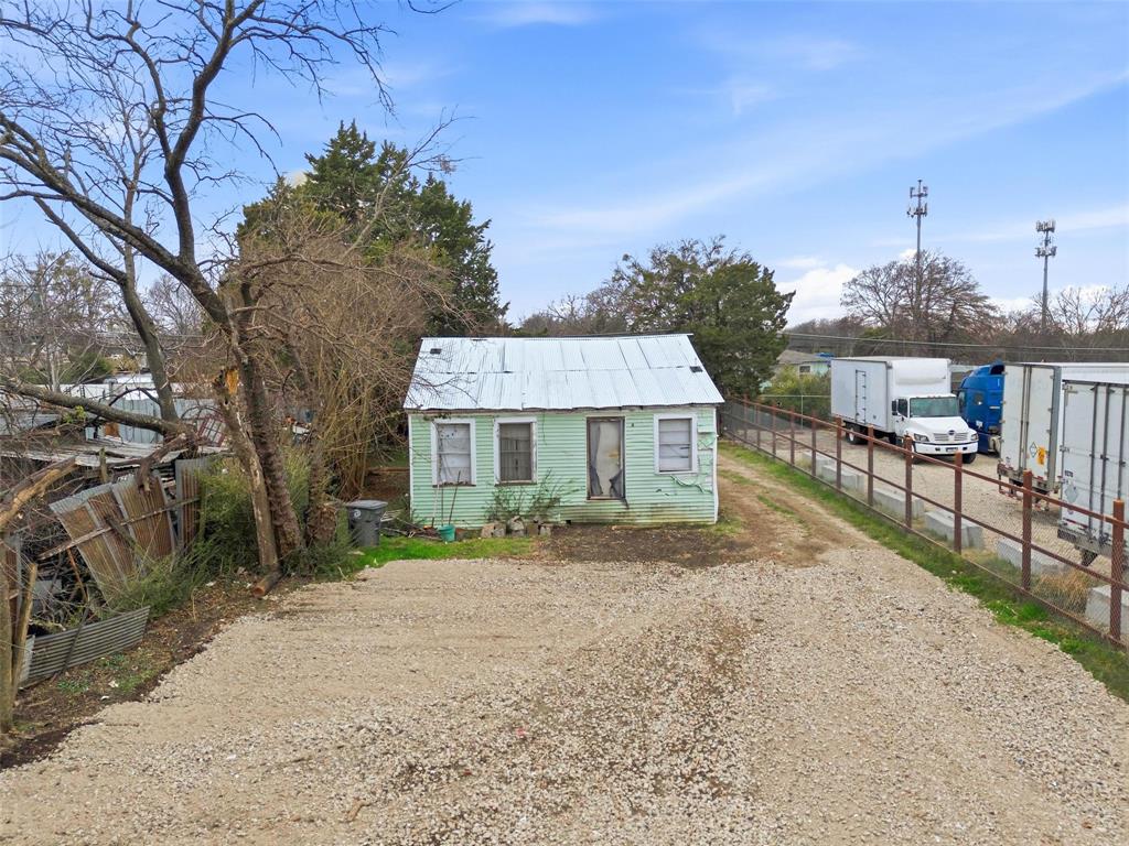 8322 Honeysuckle Lane Dallas, TX 75241 - Photo 9 of 15 a view of a house with a yard and potted plants