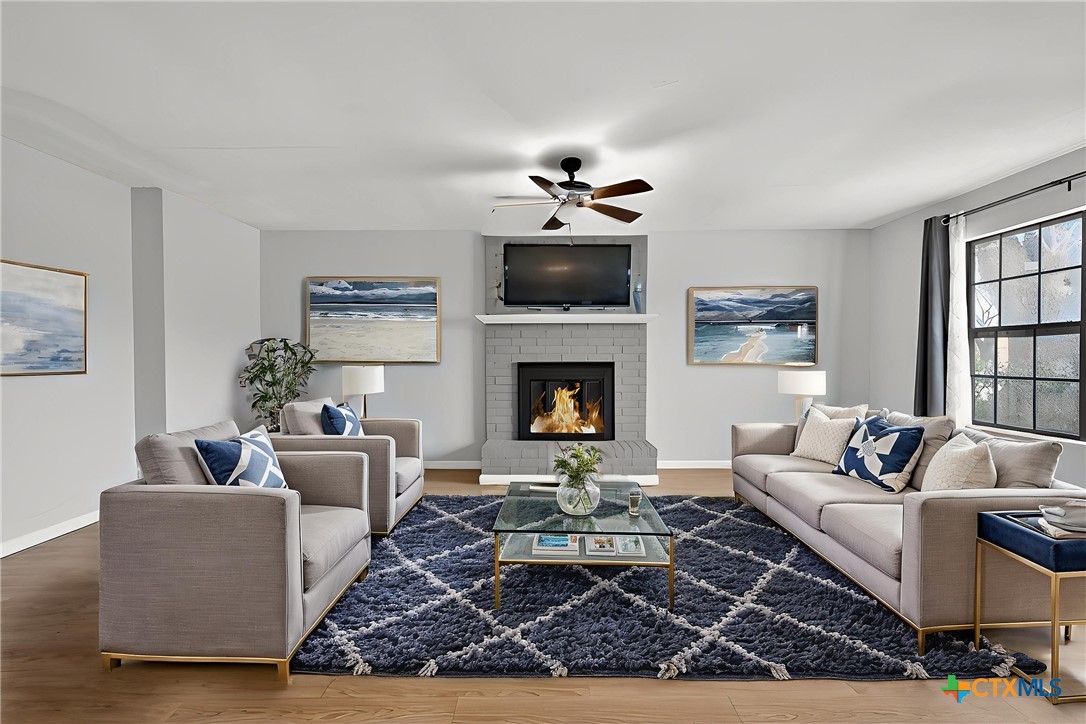 3421 Chisholm Trail Killeen, TX 76542 - Photo 6 of 34 a living room with furniture a flat screen tv and a fireplace