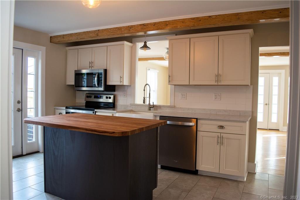 6 West Main Street Chester, CT 06412 - Photo 11 of 37 a kitchen with stainless steel appliances granite countertop a sink stove and refrigerator