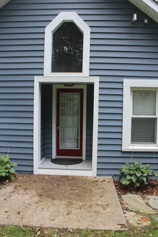 a view of a house with white door and a window