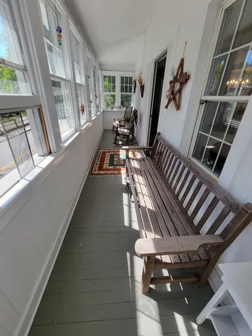 a view of an entryway with wooden floor