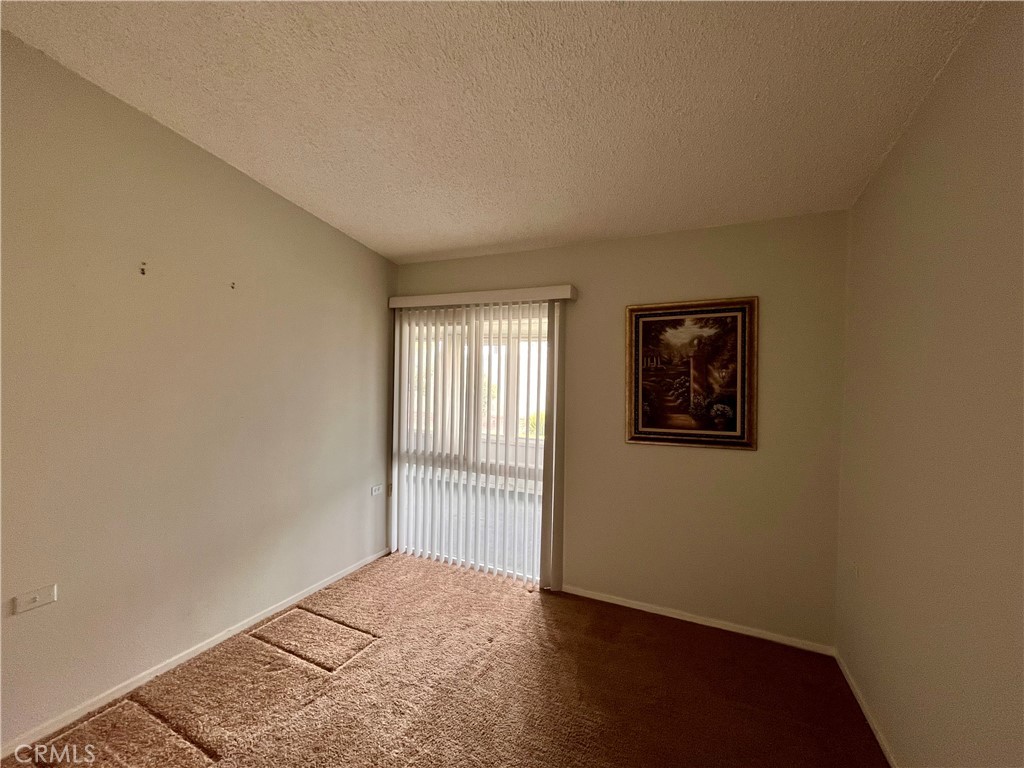 1842 Thunderbird Drive, Unit 1C Seal Beach, CA 90740 - Photo 12 of 16 an empty room with wooden floor and windows