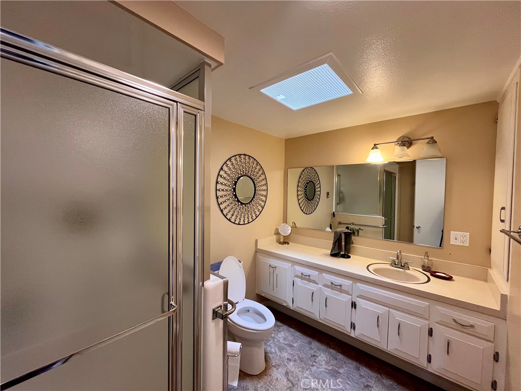 1842 Thunderbird Drive, Unit 1C Seal Beach, CA 90740 - Photo 14 of 16 a bathroom with a double vanity sink mirror and toilet