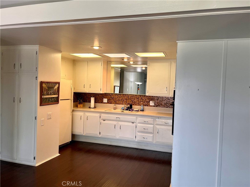 1842 Thunderbird Drive, Unit 1C Seal Beach, CA 90740 - Photo 9 of 16 a bathroom with a double vanity sink and mirror