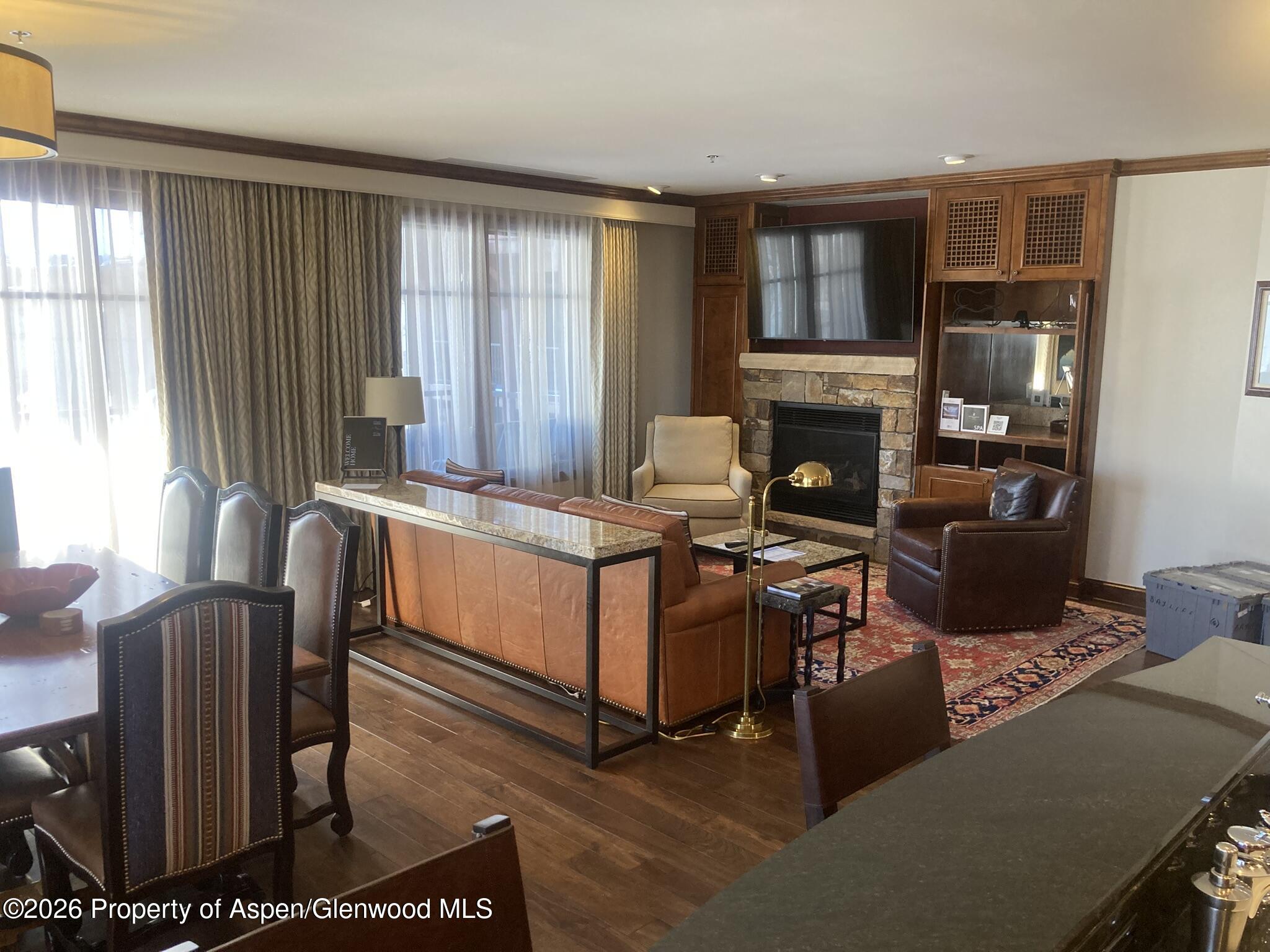 39 Boomerang Road, Unit 841010 Aspen, CO 81611 - Photo 6 of 21 a living room with furniture a fireplace and a window
