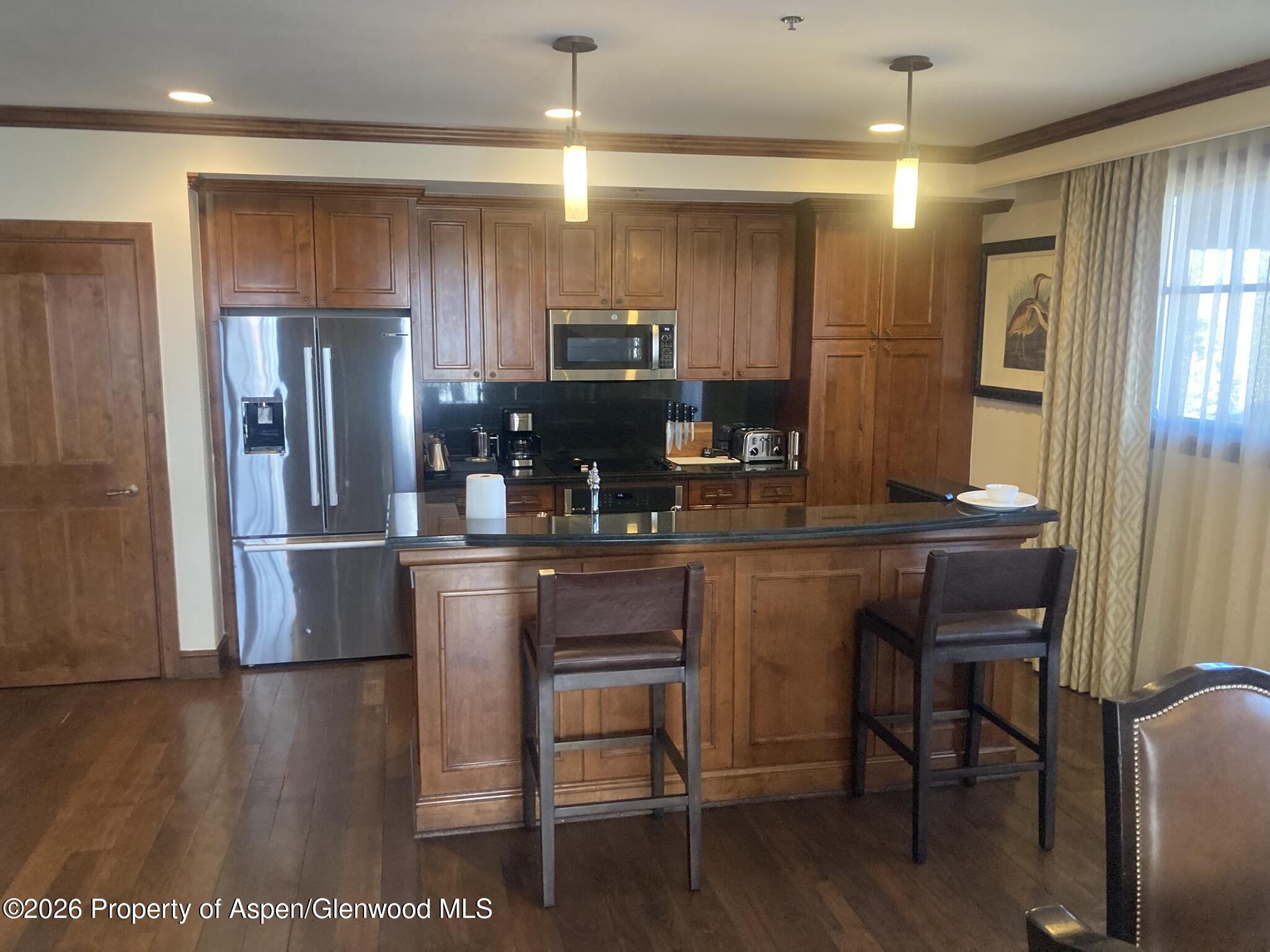 39 Boomerang Road, Unit 841010 Aspen, CO 81611 - Photo 8 of 21 a kitchen with a table and chairs