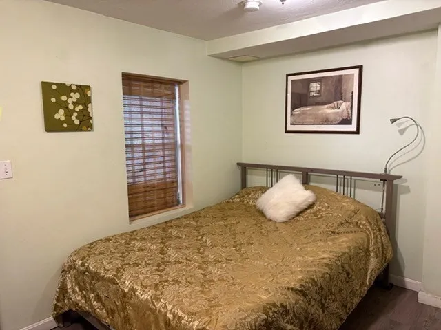a view of a closet with wooden floor