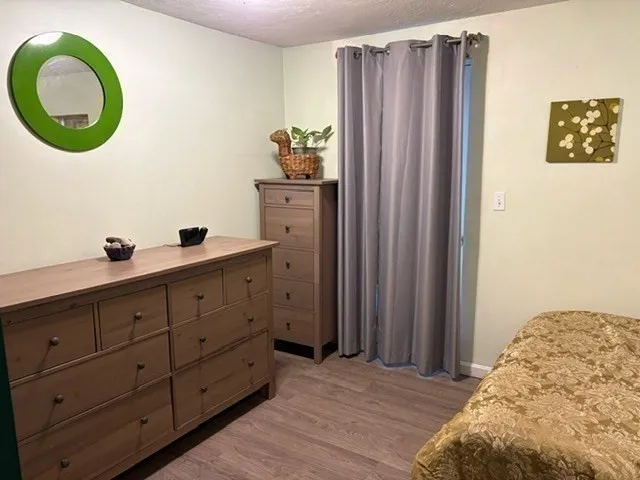 a view of a hallway with wooden floor and windows