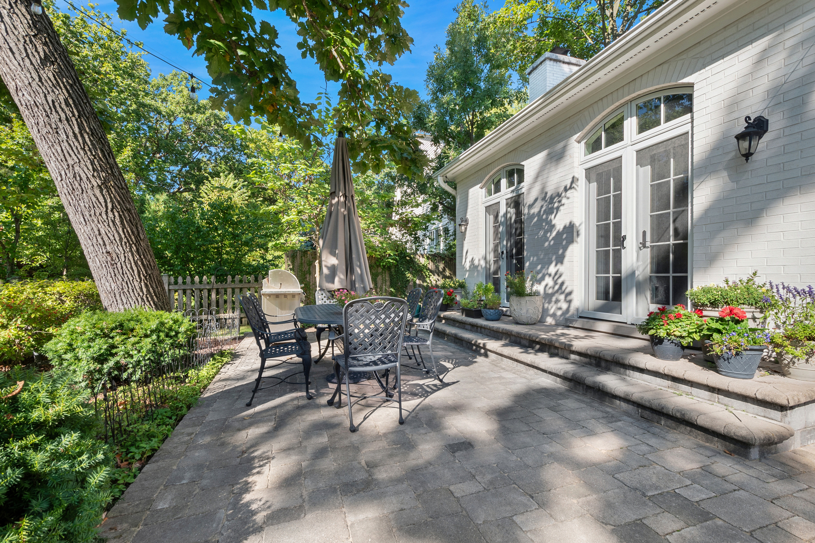 1317 Maple Avenue Wilmette, IL 60091 - Photo 7 of 15 a view of a patio with table and chairs and potted plants