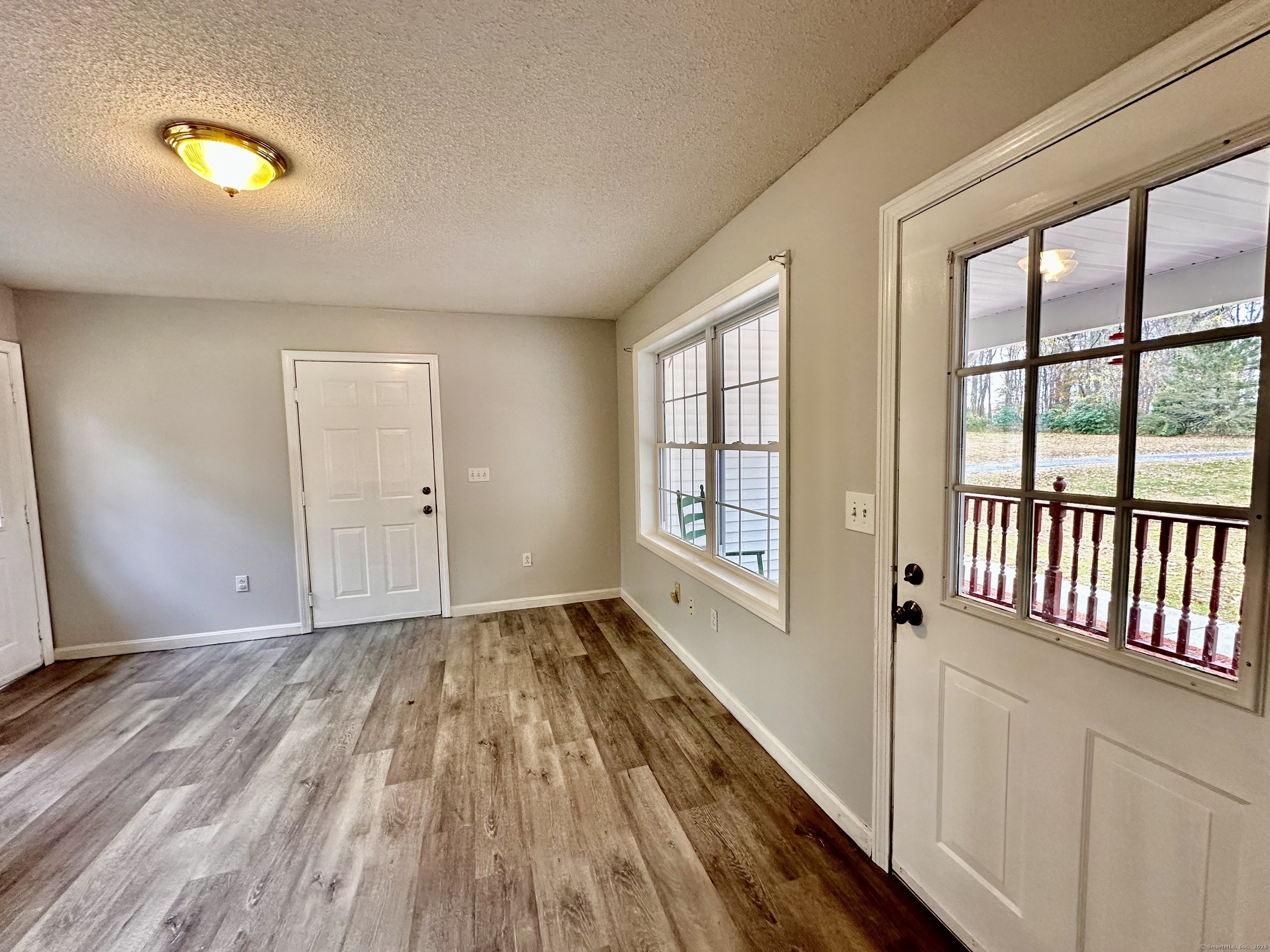 288 Leonard Bridge Road Lebanon, CT 06249 - Photo 9 of 14 wooden floor in an empty room with a window