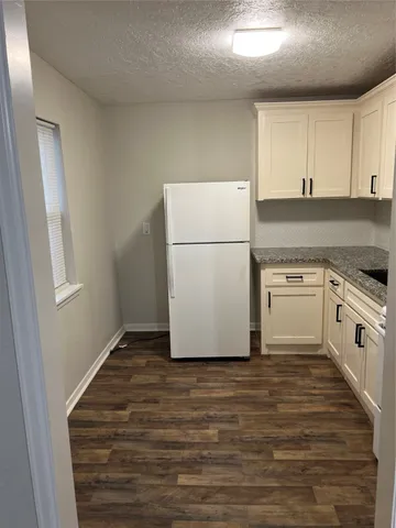 a view of a kitchen with refrigerator and microwave