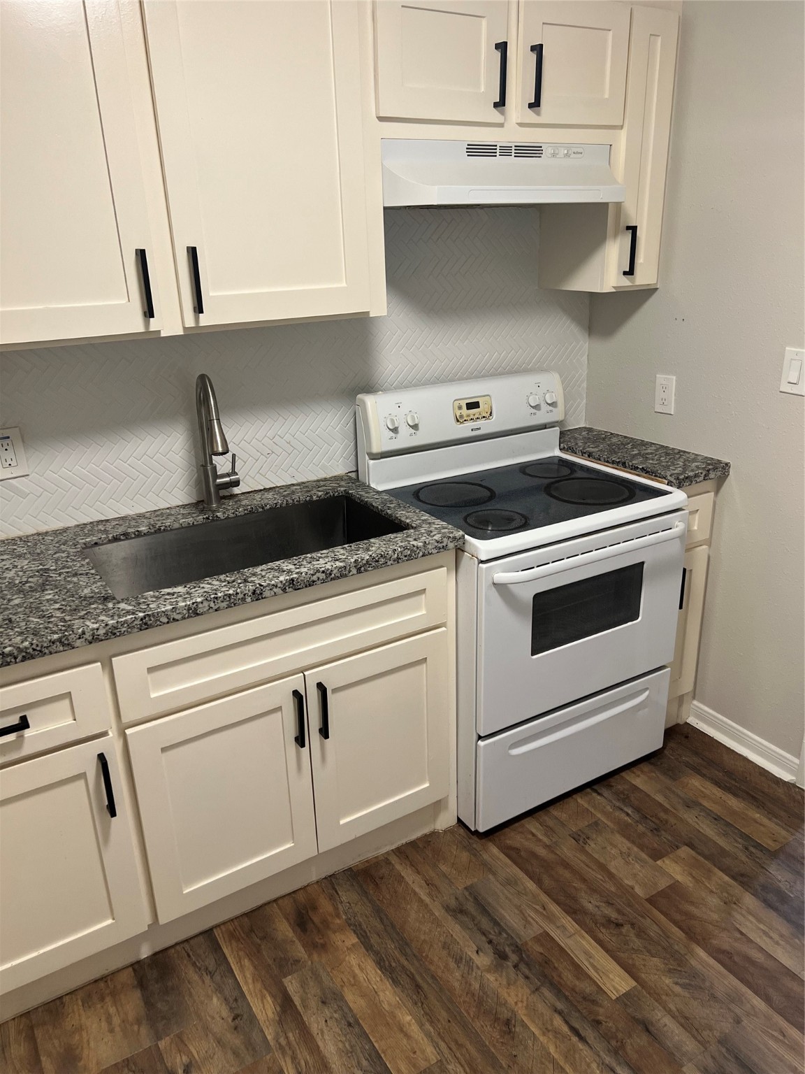 7909 Brutus Street, Unit 4 Houston, TX 77012 - Photo 5 of 9 a white stove top oven sitting inside of a kitchen