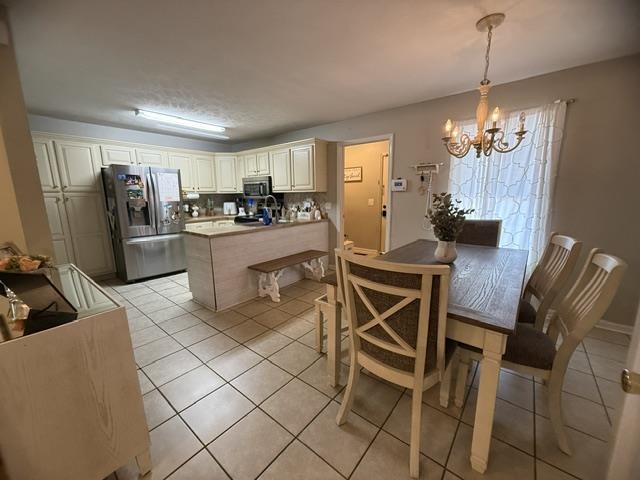 395 Austin Street Savannah, TN 38372 - Photo 8 of 32 Kitchen with tile flooring and cream cabinetry