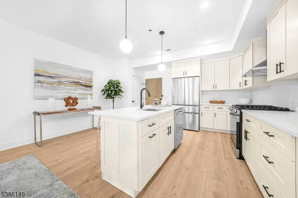 a kitchen with white cabinets and white appliances