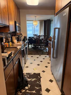 a kitchen with stainless steel appliances a sink a stove a refrigerator and cabinets