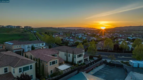 an aerial view of residential houses with outdoor space and mountain view