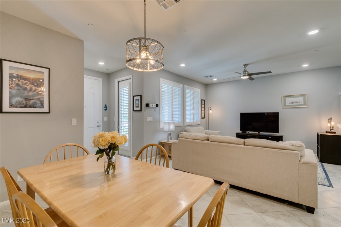 2870 Turnstone Ridge Street Henderson, NV 89044 - Photo 16 of 50 Dining area featuring light tile patterned floors, a ceiling fan, recessed lighting, and a chandelier