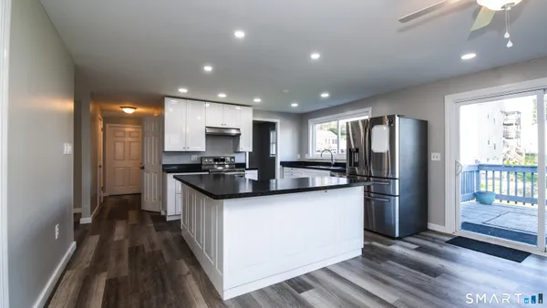 a kitchen with stainless steel appliances granite countertop a refrigerator stove and sink