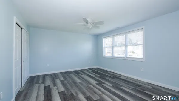 wooden floor in an empty room with a window