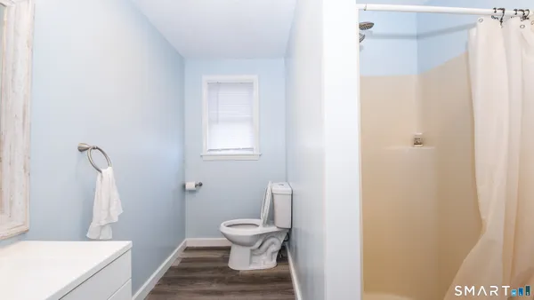 a white toilet sitting next to a bathroom sink