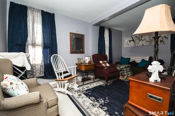a living room with furniture rug and window