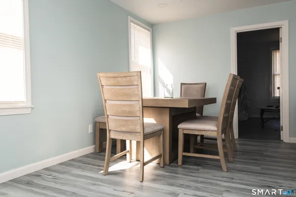 a dining room with furniture and wooden floor