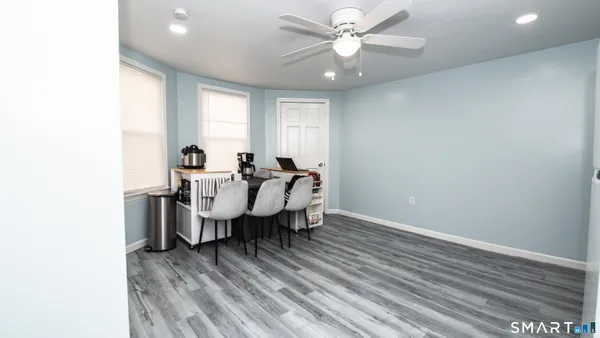 a view of a dining room with furniture window and wooden floor