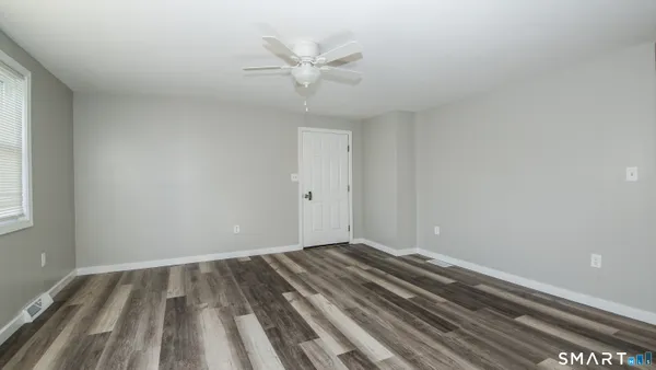 a view of room with window and ceiling fan