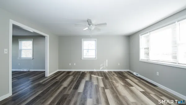wooden floor in an empty room with a window
