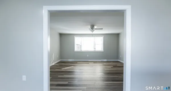 a view of room with window and hardwood floor