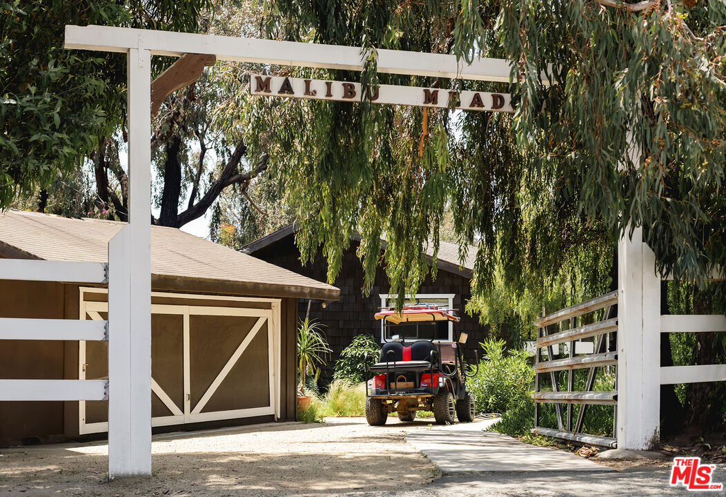 a front view of a building with street view and trees