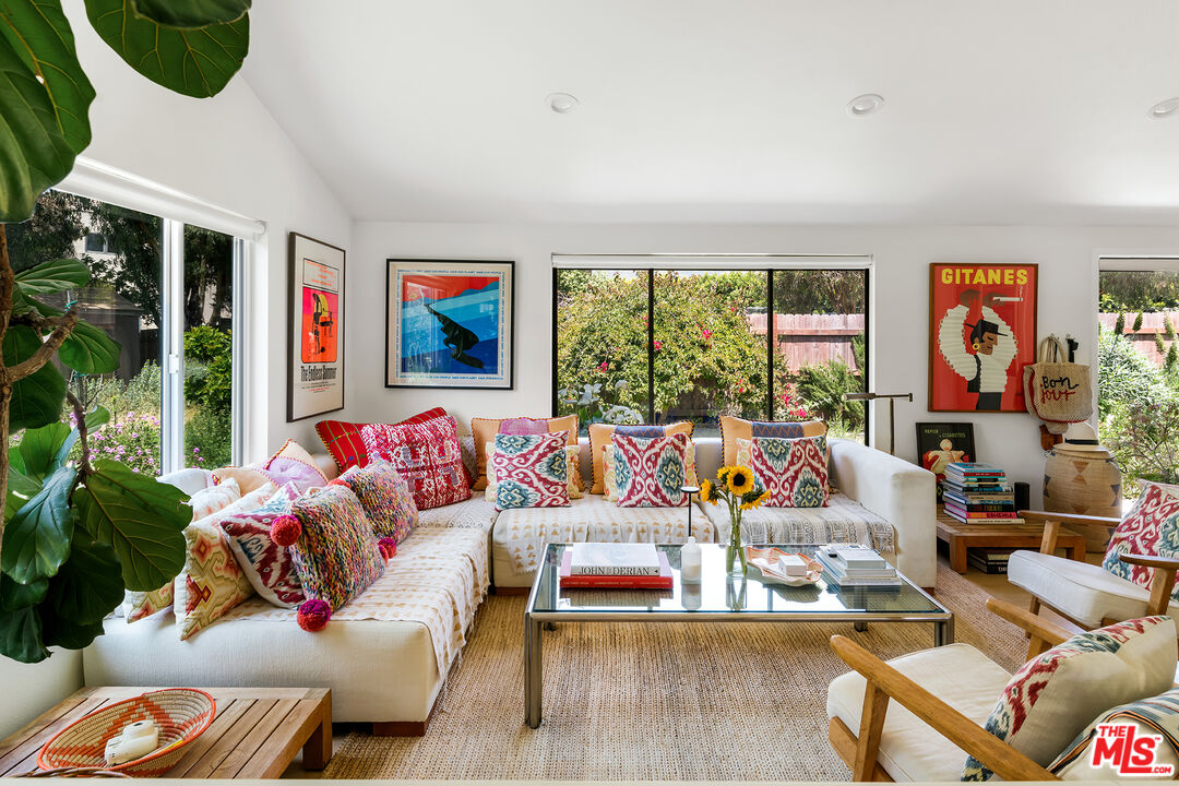 6551 Zumirez Drive Malibu, CA 90265 - Photo 11 of 36 a living room with furniture fireplace and window
