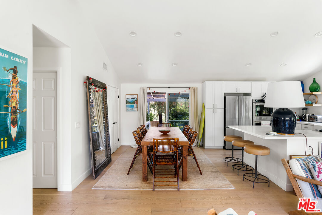 6551 Zumirez Drive Malibu, CA 90265 - Photo 15 of 36 a dining room with furniture and wooden floor