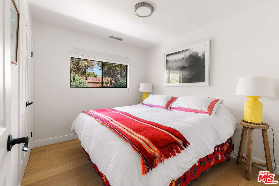 6551 Zumirez Drive Malibu, CA 90265 - Photo 17 of 36 a bedroom with a bed and painting on the wall