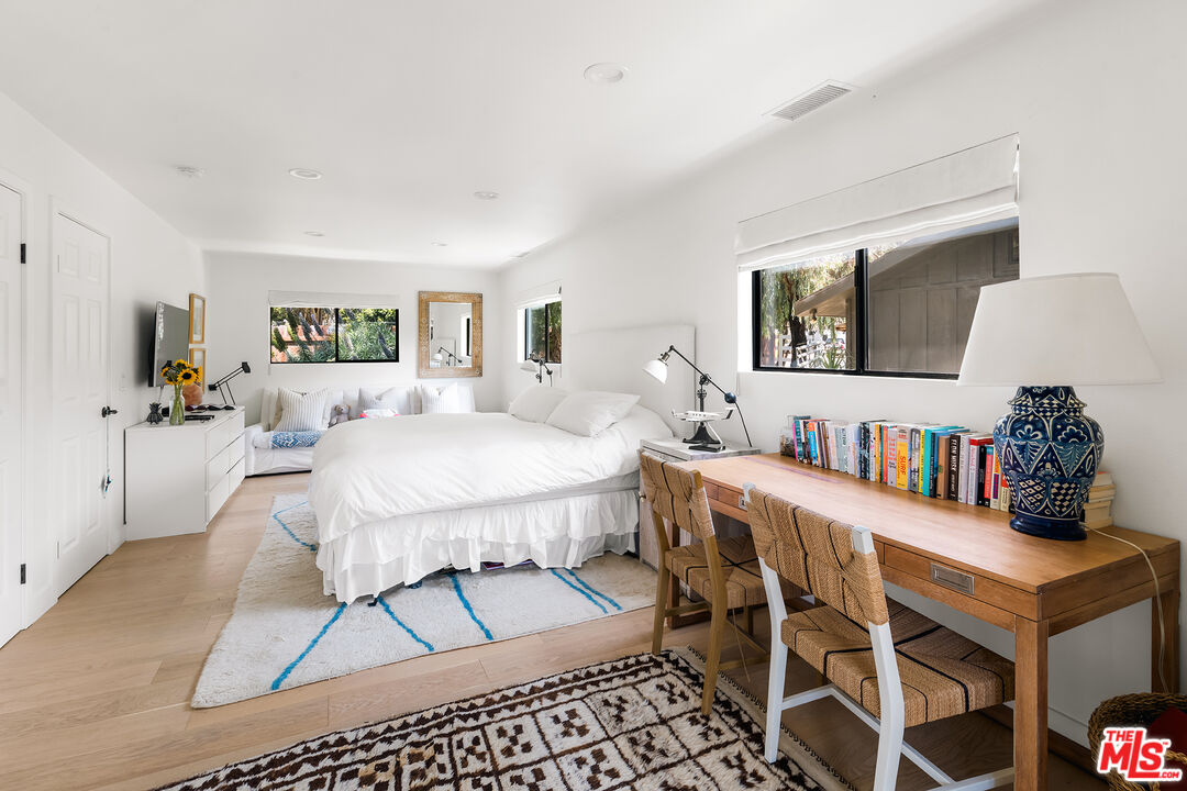 6551 Zumirez Drive Malibu, CA 90265 - Photo 20 of 36 a living room with furniture a flat screen tv and a table